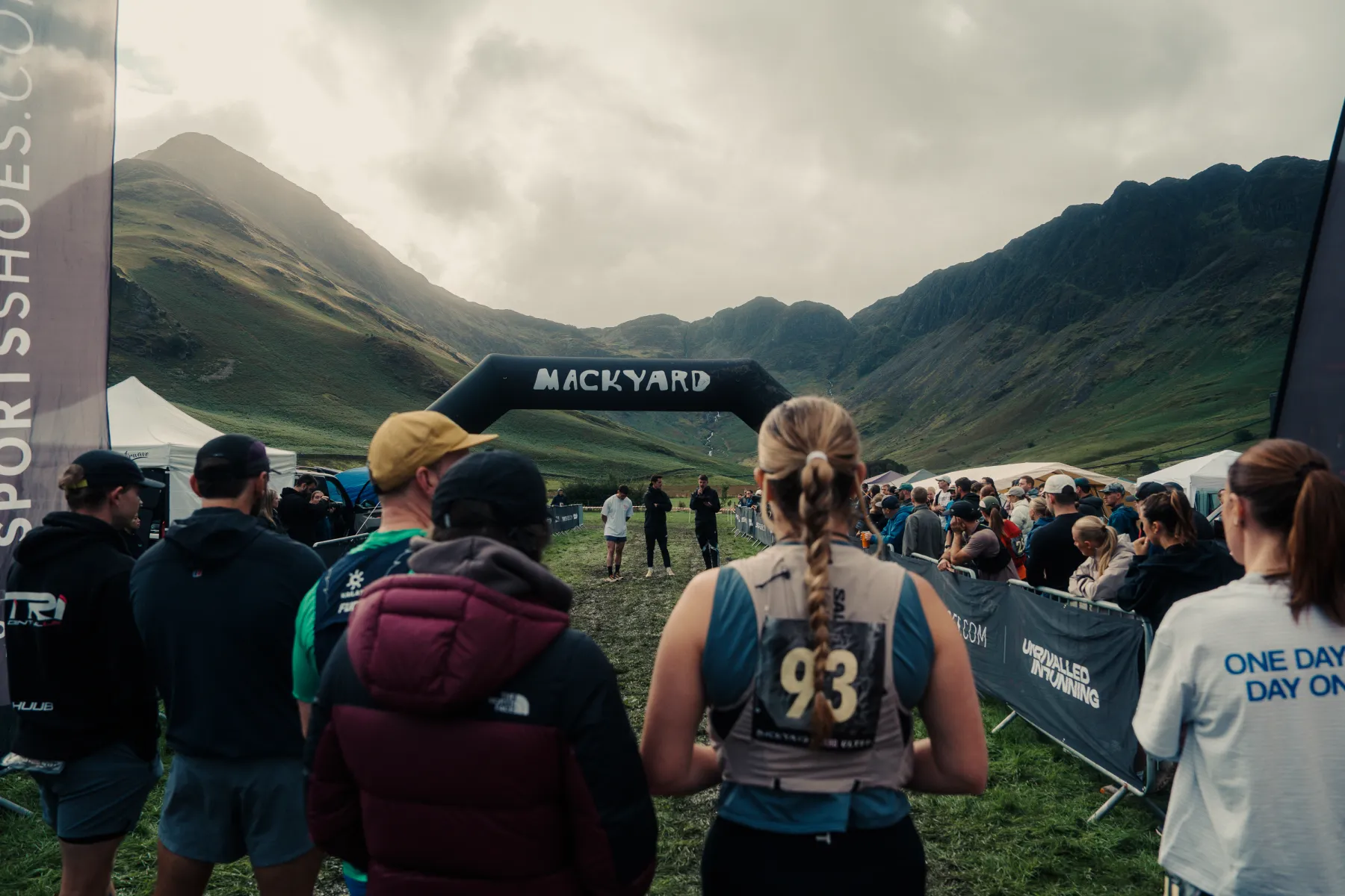 Runners gathered for the race briefing under the Mackyard start arch, with the Lake District fells behind