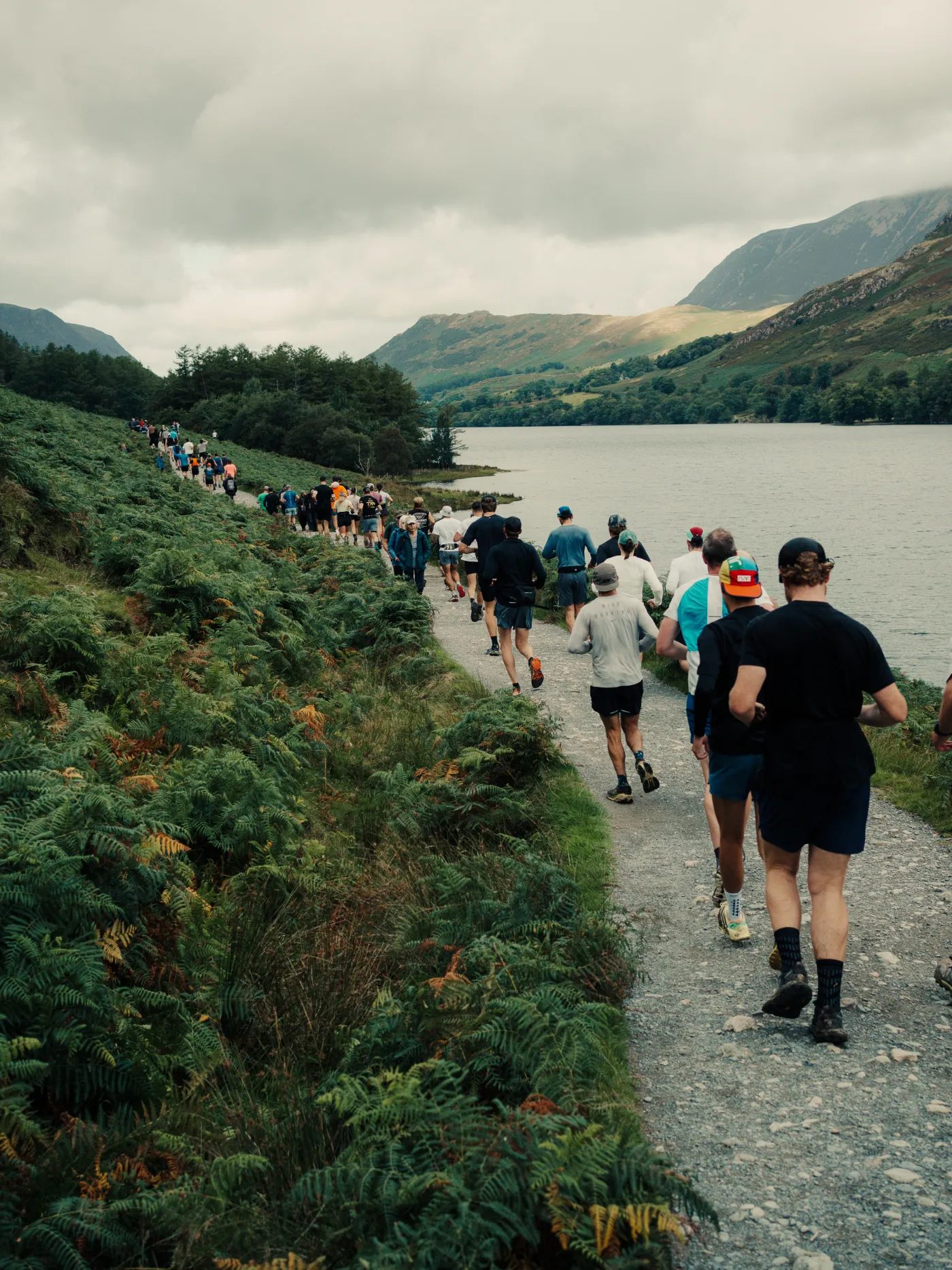A long line of runners on the lakeside trail during a yard at the Mackyard Events backyard ultra