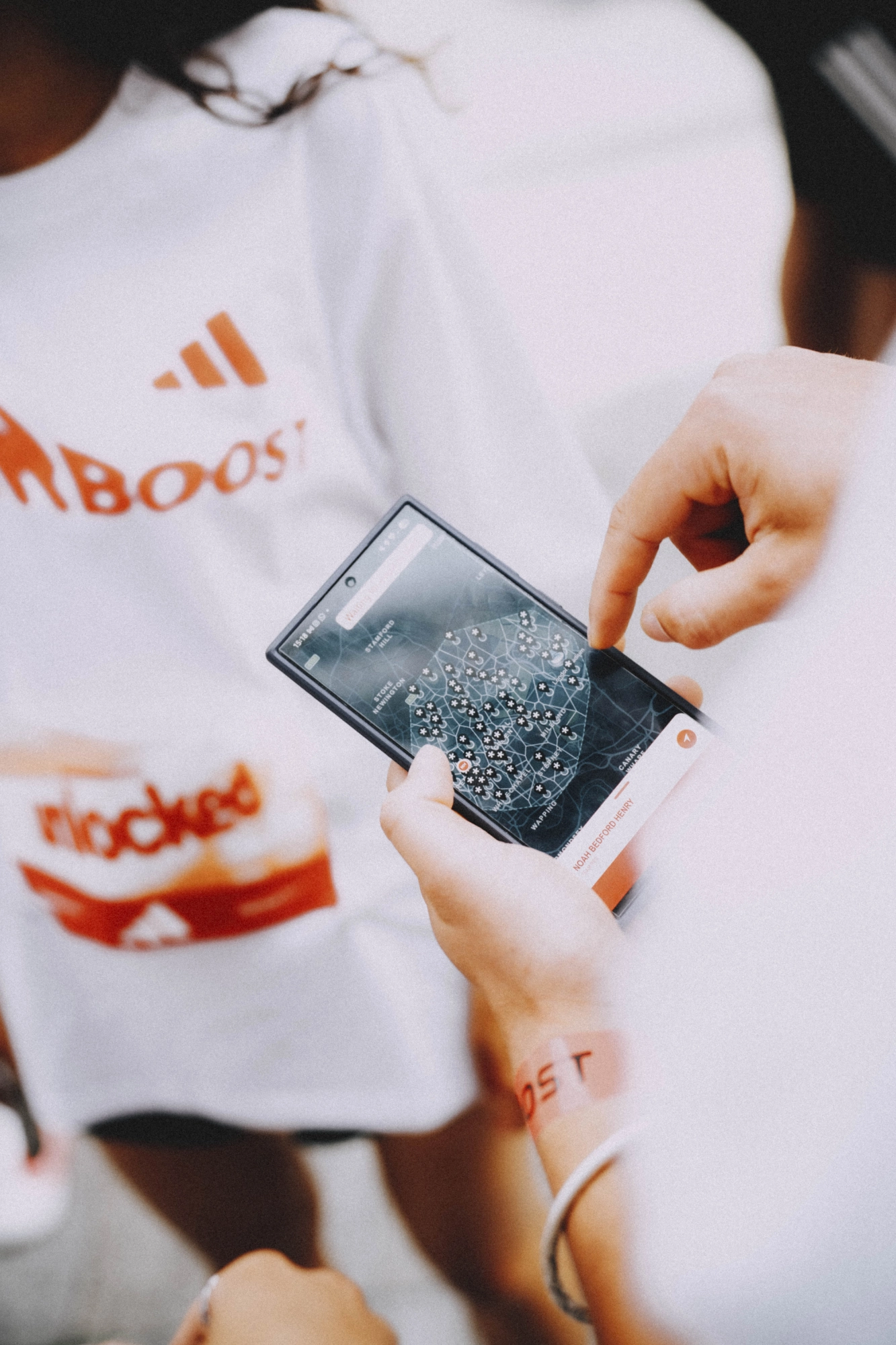 Athlete checking the adidas-branded race app mid-event