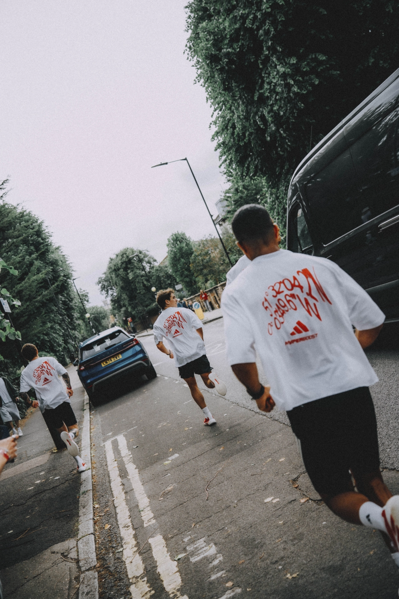 Athletes racing through the streets in adidas Hyperboost shirts
